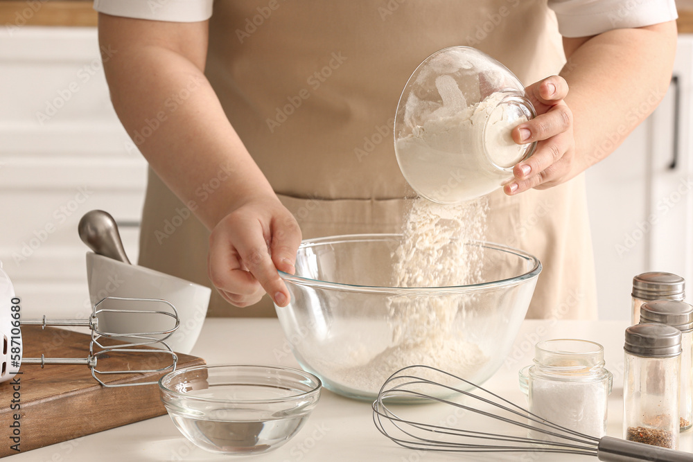 Woman preparing dough for Italian Grissini at table in kitchen, closeup