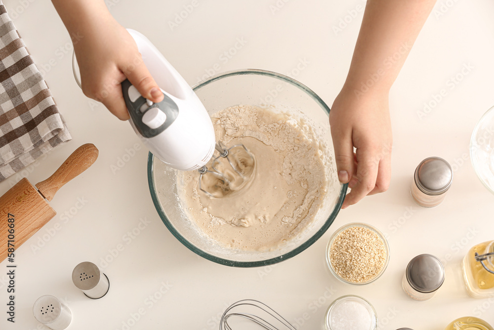 Woman preparing dough for Italian Grissini on white background