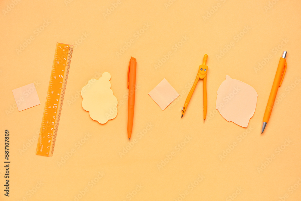 Composition with sticky notes, pens and ruler on yellow background