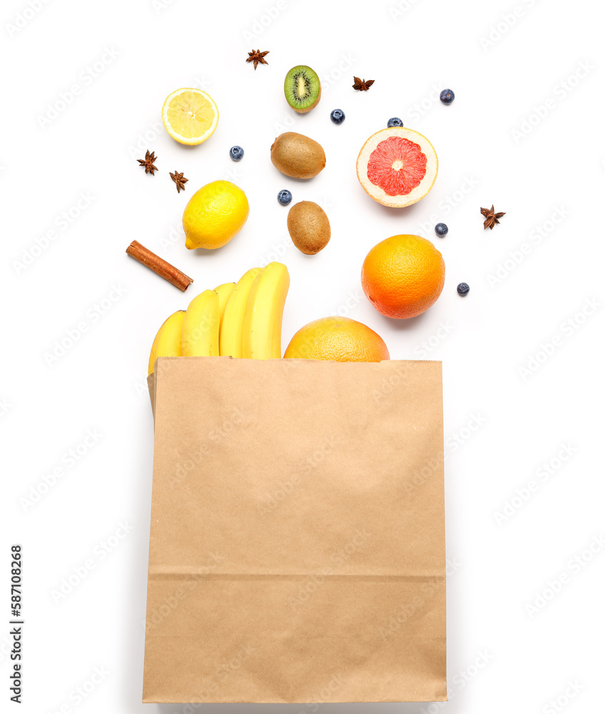 Paper bag with fruits on white background