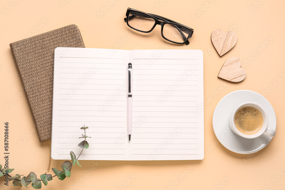 Composition with blank notebook, coffee cup and glasses on beige background