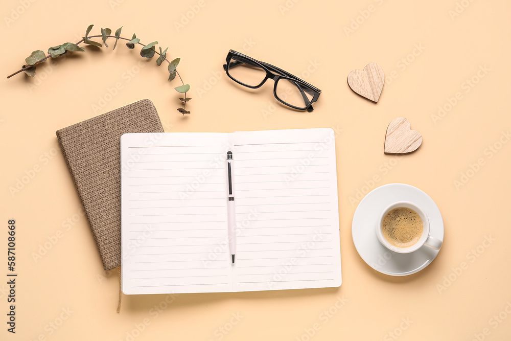 Composition with blank notebook, coffee cup and glasses on beige background