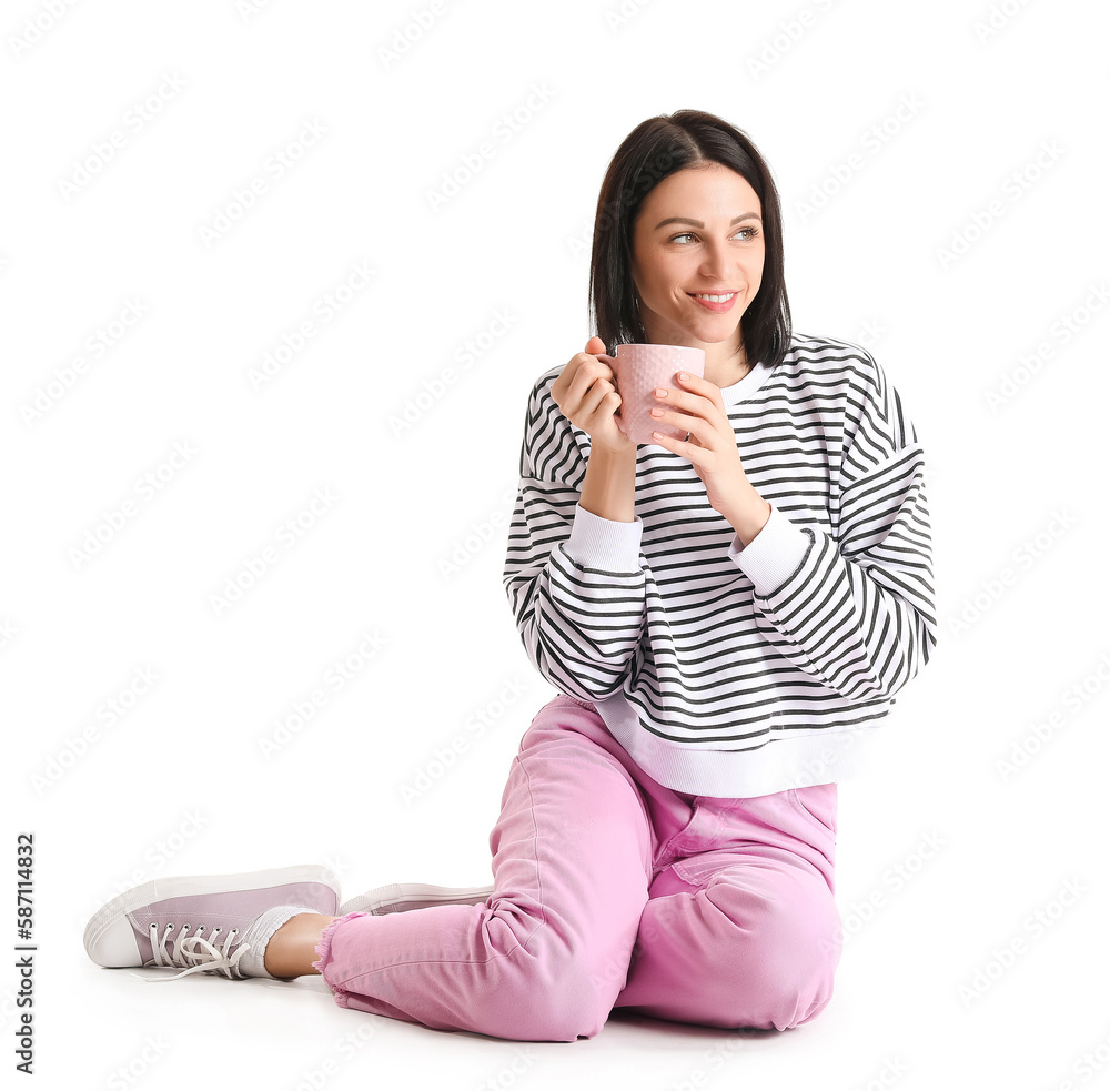 Pretty young woman with cup of hot coffee isolated on white