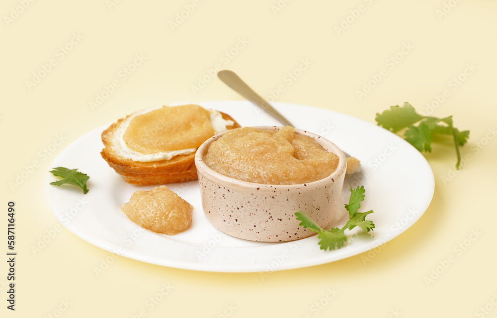 Bowl with caviar of capelin and canape on beige background