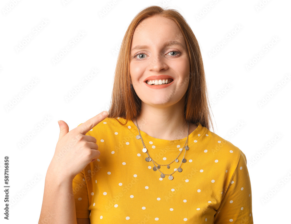 Beautiful redhead woman in yellow dress showing thumb-up on white background