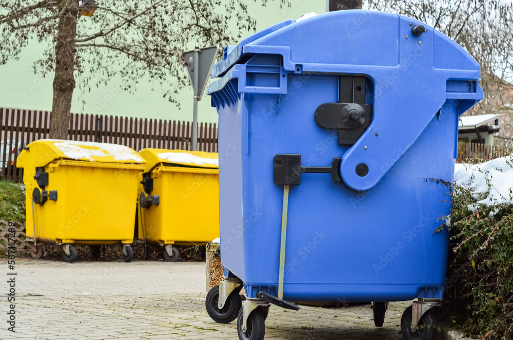 View of garbage containers in city on winter day