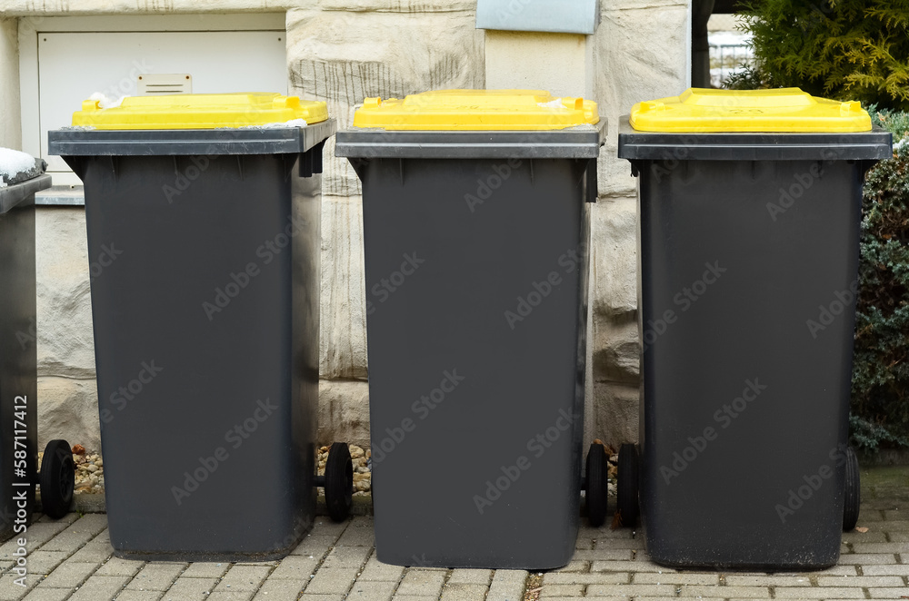 View of garbage containers in city on winter day