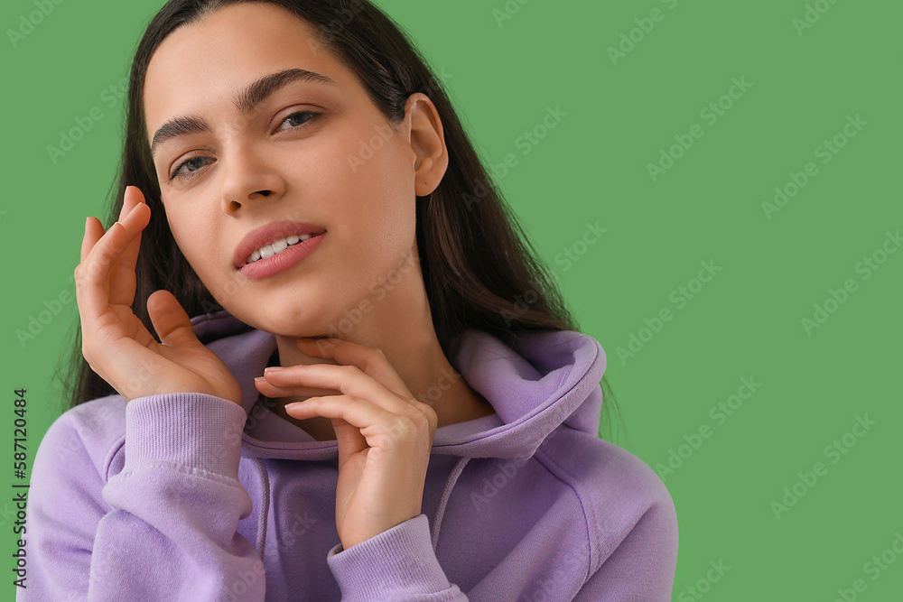 Beautiful young woman on green background, closeup