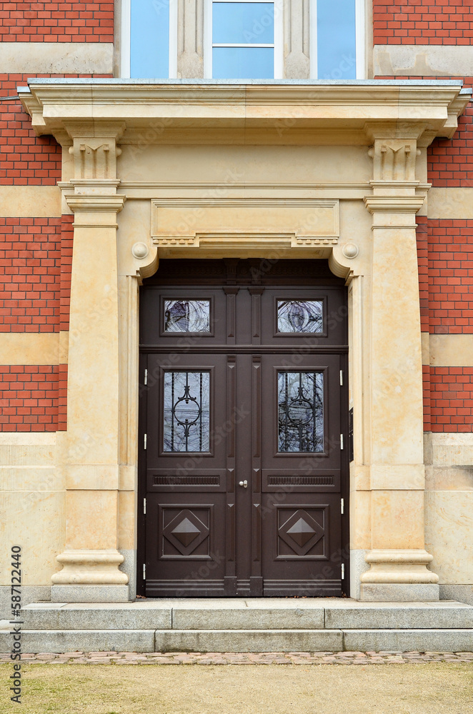 View of brick building with wooden door