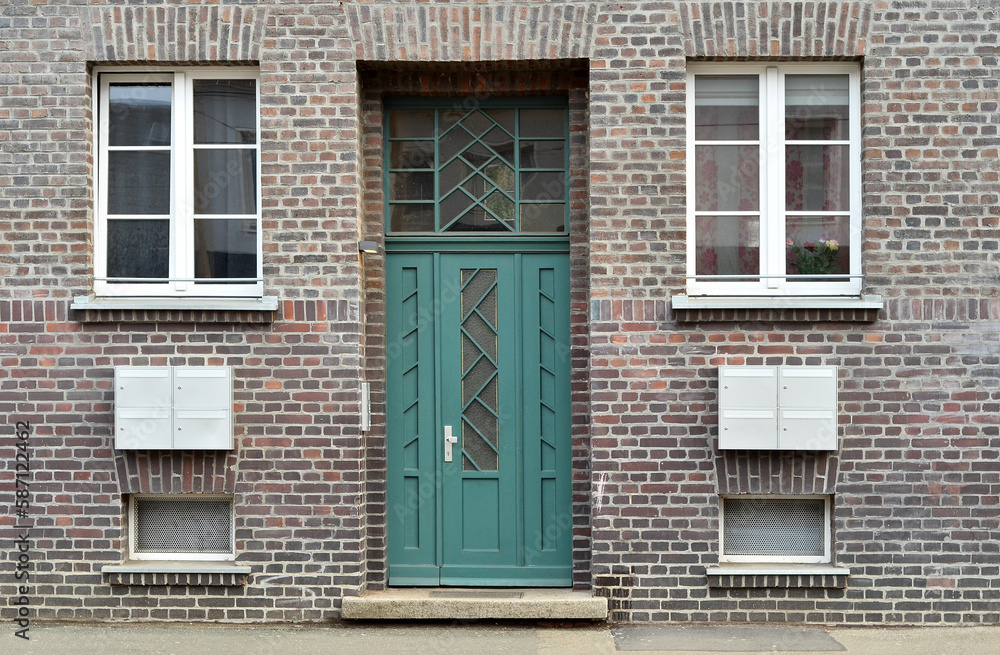 View of brick building with green door and windows