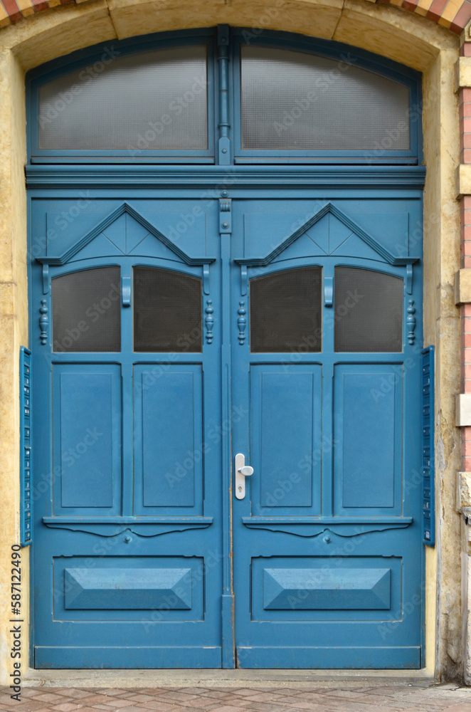 View of old building with blue wooden door