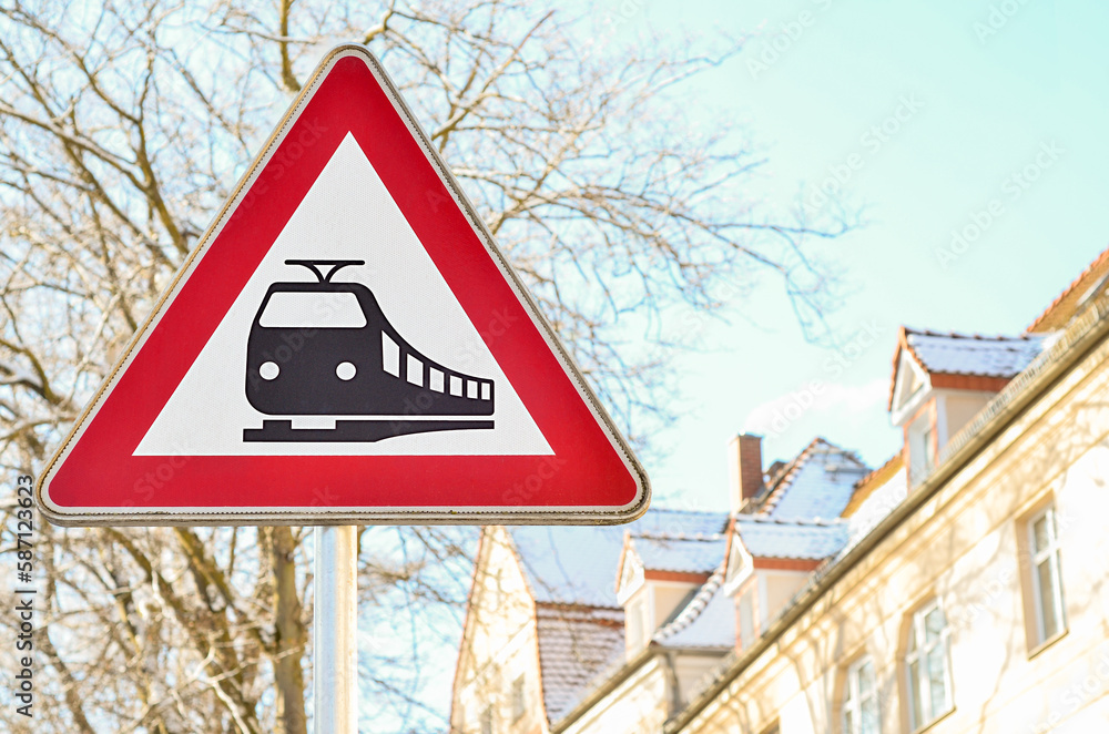 Warning sign for railroad crossing in city, closeup