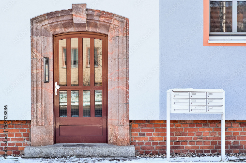 View of residential building with door and mailboxes