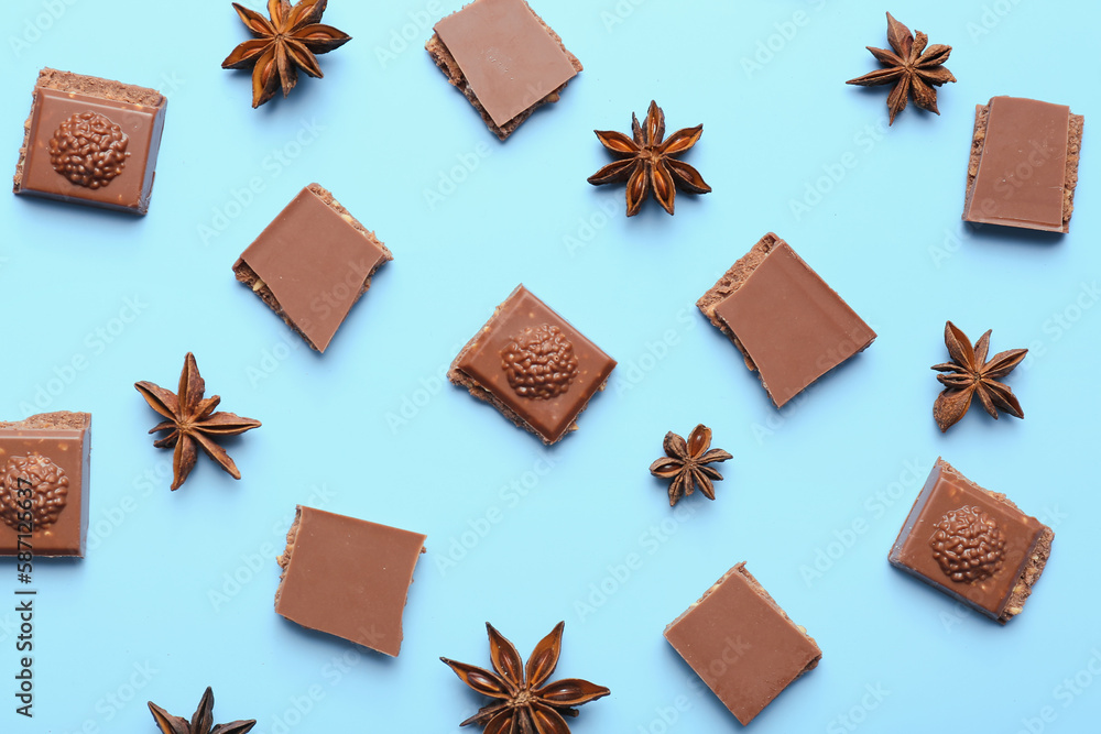 Composition with pieces of tasty chocolate and anise stars on color background