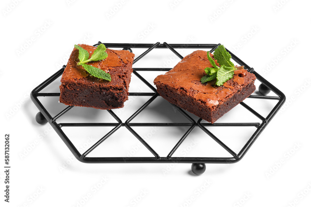 Grid with pieces of tasty chocolate brownie isolated on white background