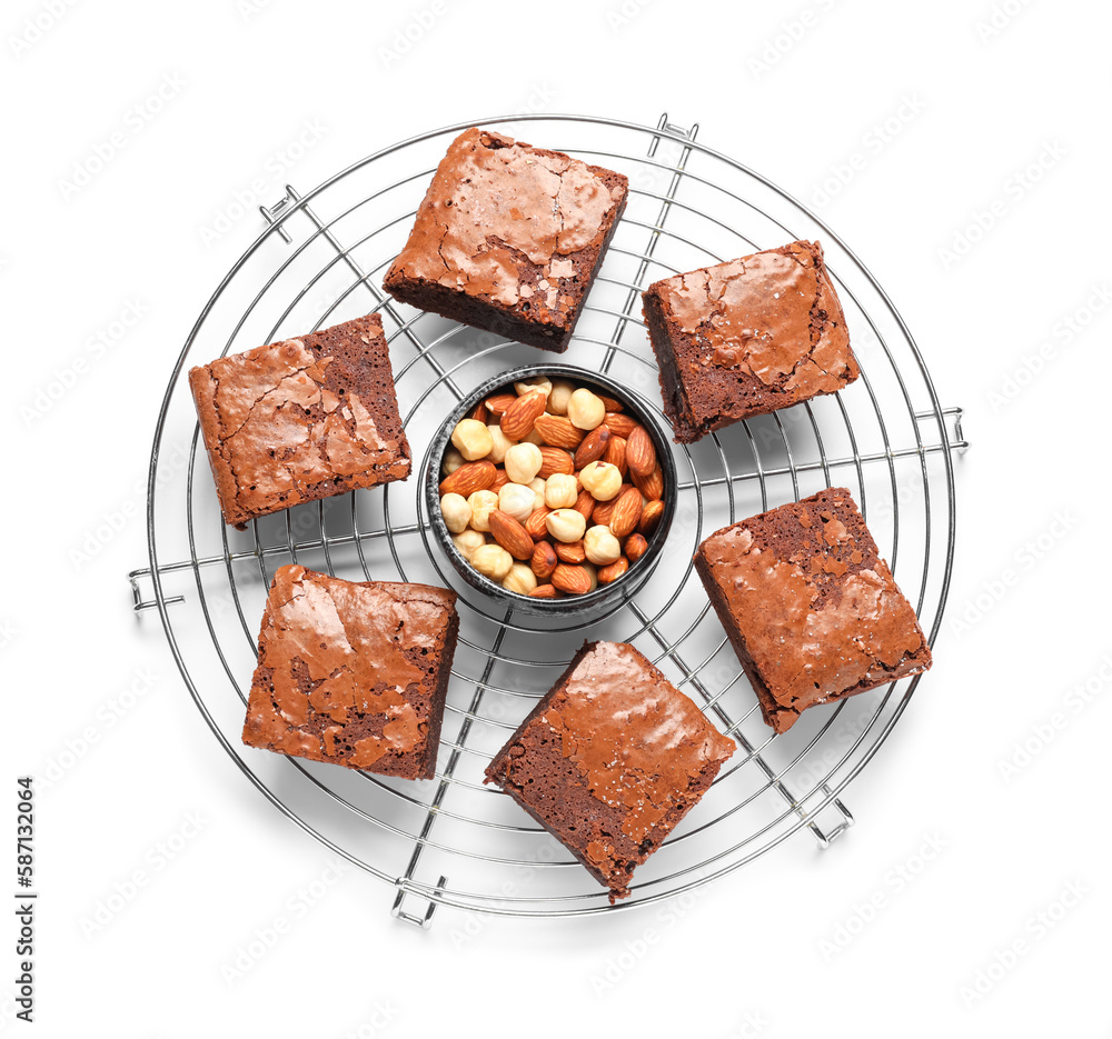 Grid with pieces of tasty chocolate brownie isolated on white background