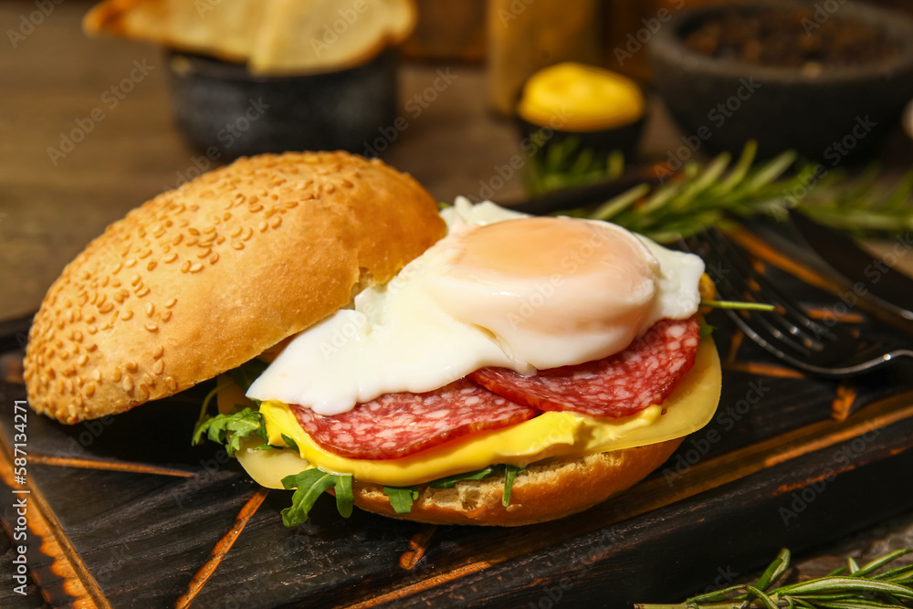 Board with tasty egg Benedict on table, closeup