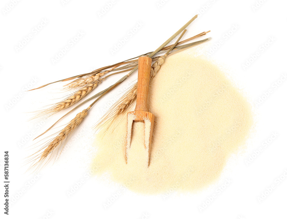 Spikelets and scoop with raw semolina on white background