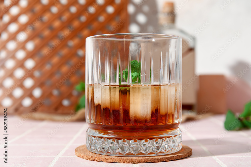 Glass of cold rum on table, closeup