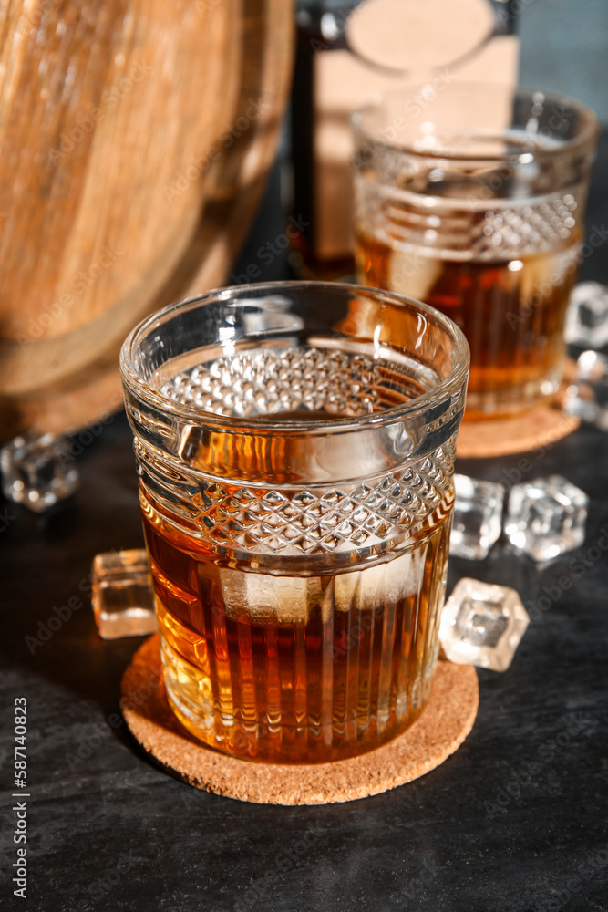 Glass of cold rum on table