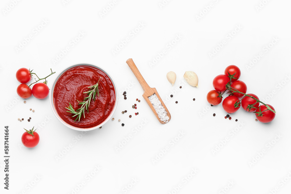 Bowl with tasty tomato paste, garlic and spices on white background