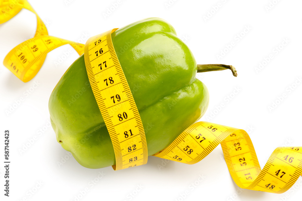 Bell pepper and yellow measuring tape on white background. Diet concept