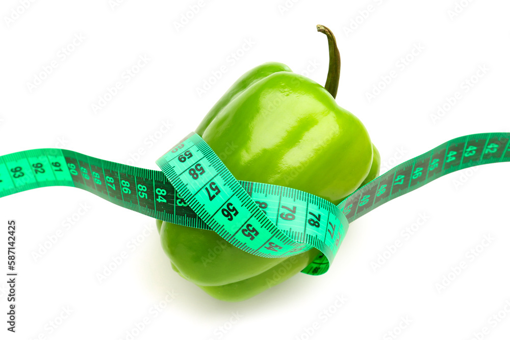 Bell pepper and green measuring tape on white background. Diet concept