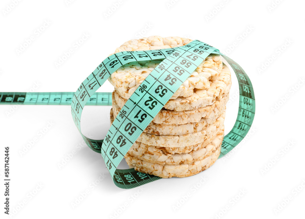 Rice cakes and blue measuring tape on white background. Diet concept