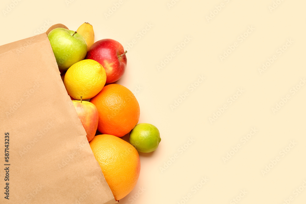 Paper bag with fruits on beige background