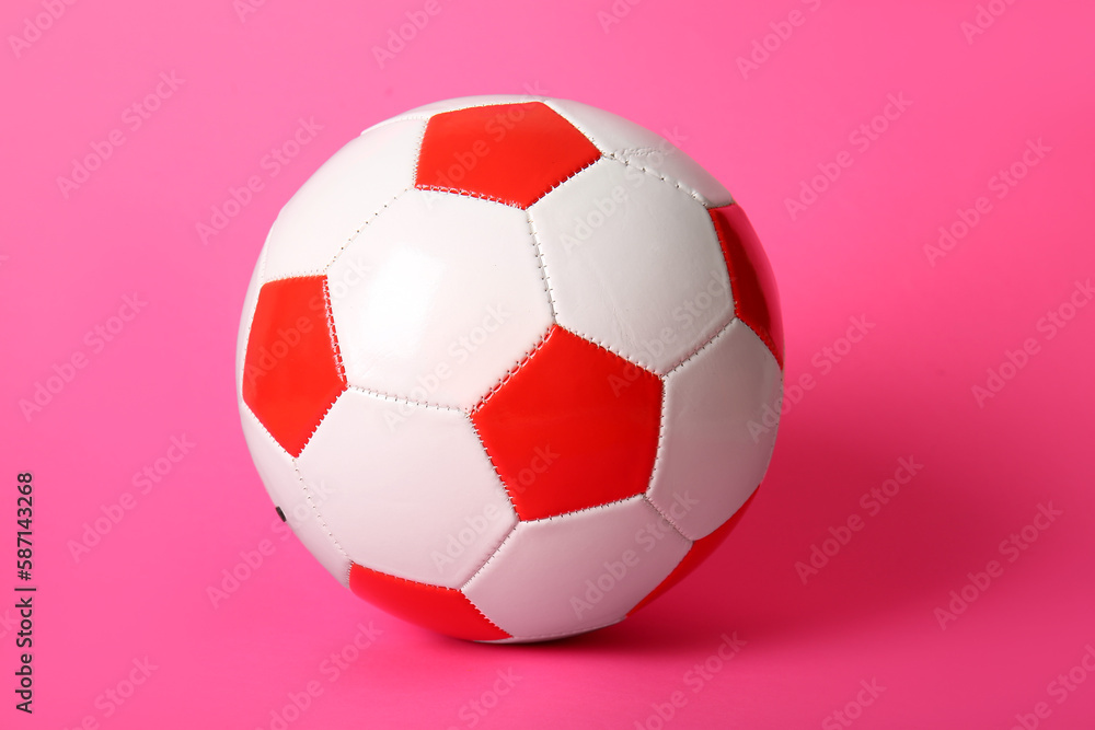 Soccer ball on pink background