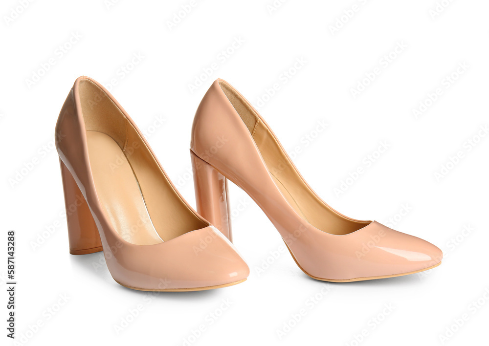 Pair of beige high heeled shoes on white background