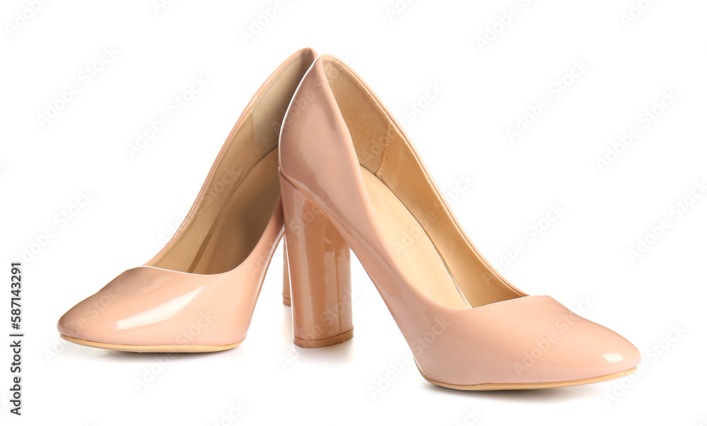 Pair of beige high heeled shoes on white background