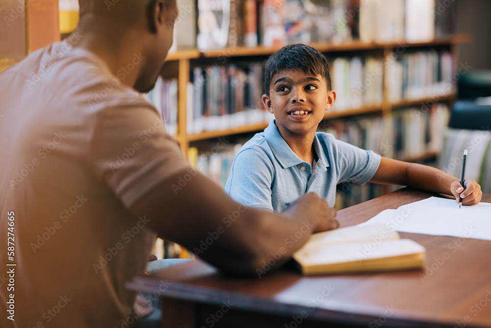 School boy getting academic support from his teacher