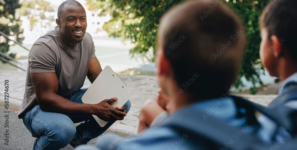 Teacher talking to his students outside class