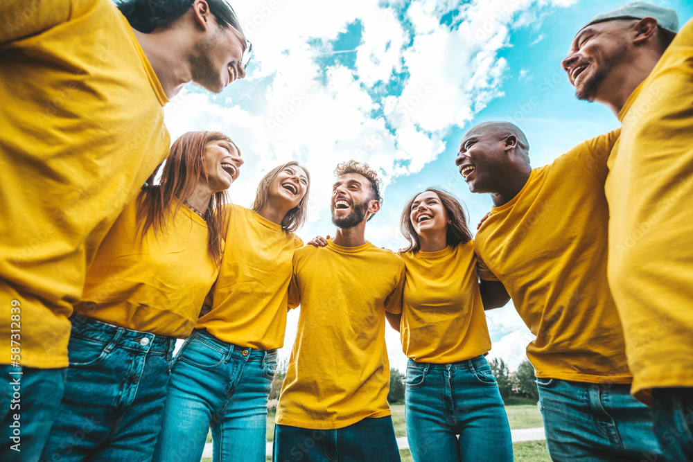 Multiracial group of people hugging outdoors - Happy friends having fun hanging outside - Youth comm