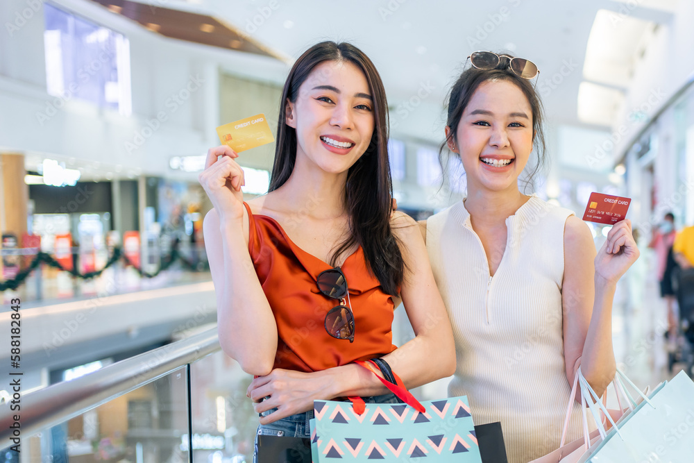 Portrait of Asian attractive two girl shopping indoor in shopping mall. 