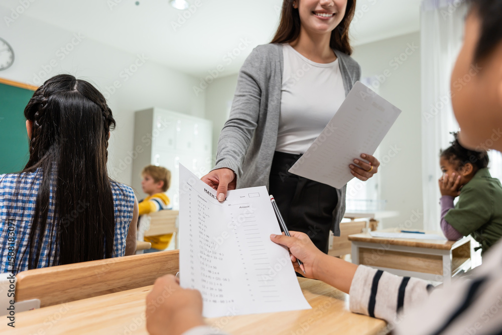 Group of student learn with teacher in classroom at elementary school. 