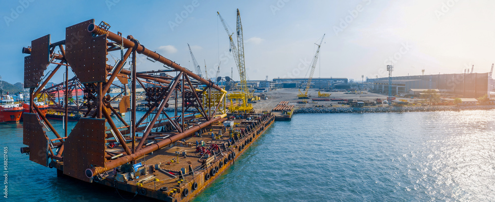 Big Drilling rid on Smart Barge. Construction port at harbor cranes at sunset. Shipyard at sunset. M