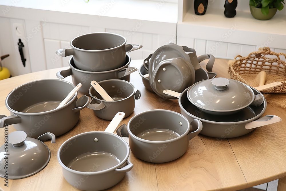  a wooden table topped with lots of gray pots and pans on top of a wooden dining room table next to 