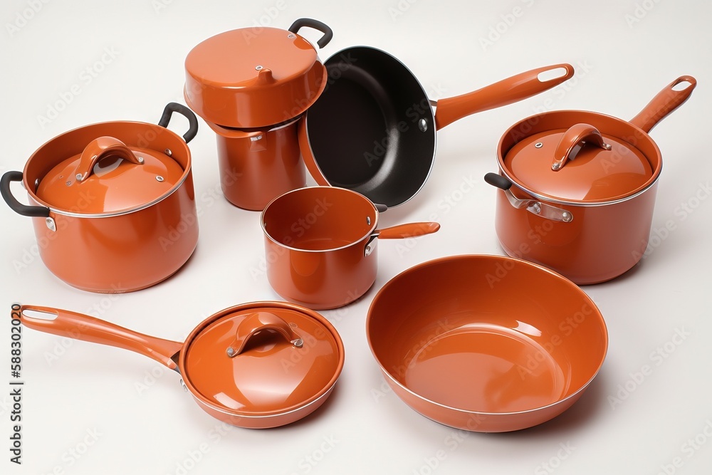  a group of orange pots and pans on a white table top with a black handle and a black handle on the 