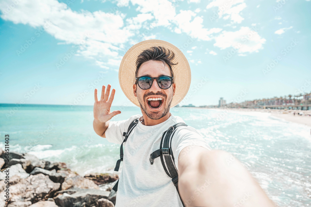 Handsome young man taking selfie at beach summer vacation - Smiling guy having fun walking outside -