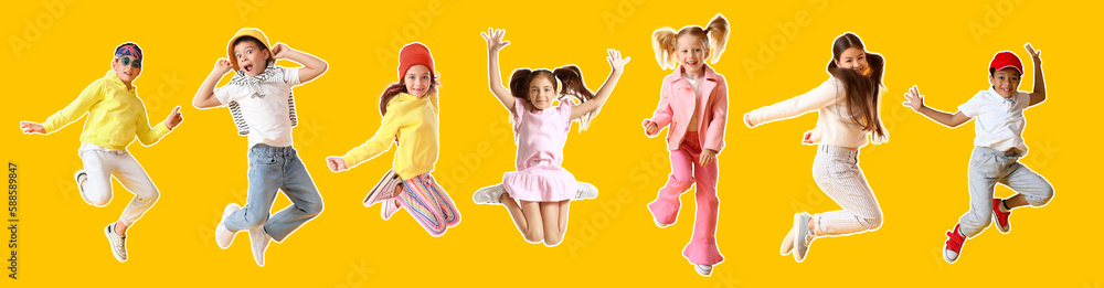 Group of jumping little children on yellow background