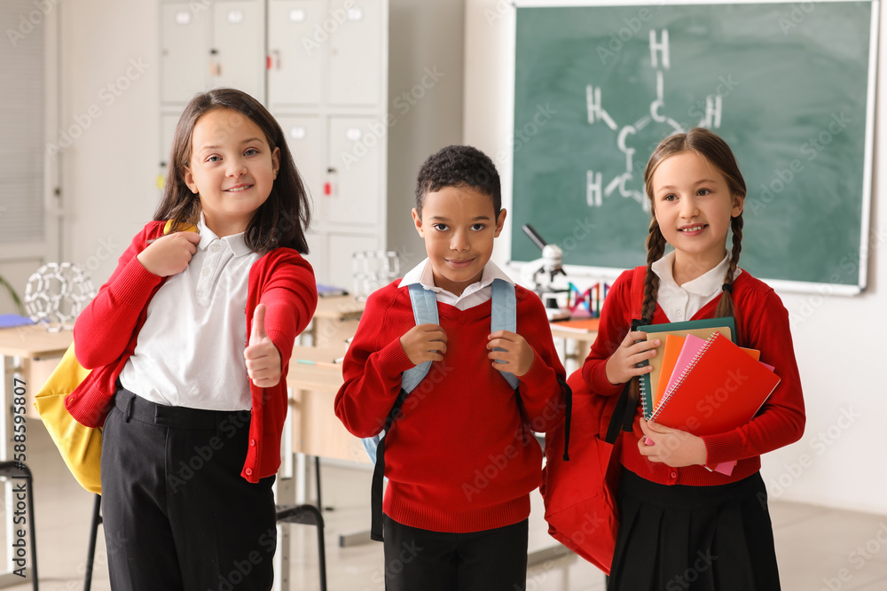 Little children with backpacks in science classroom