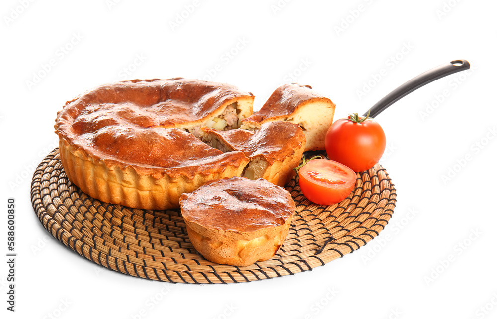 Wicker mat with delicious meat pies and tomatoes isolated on white background