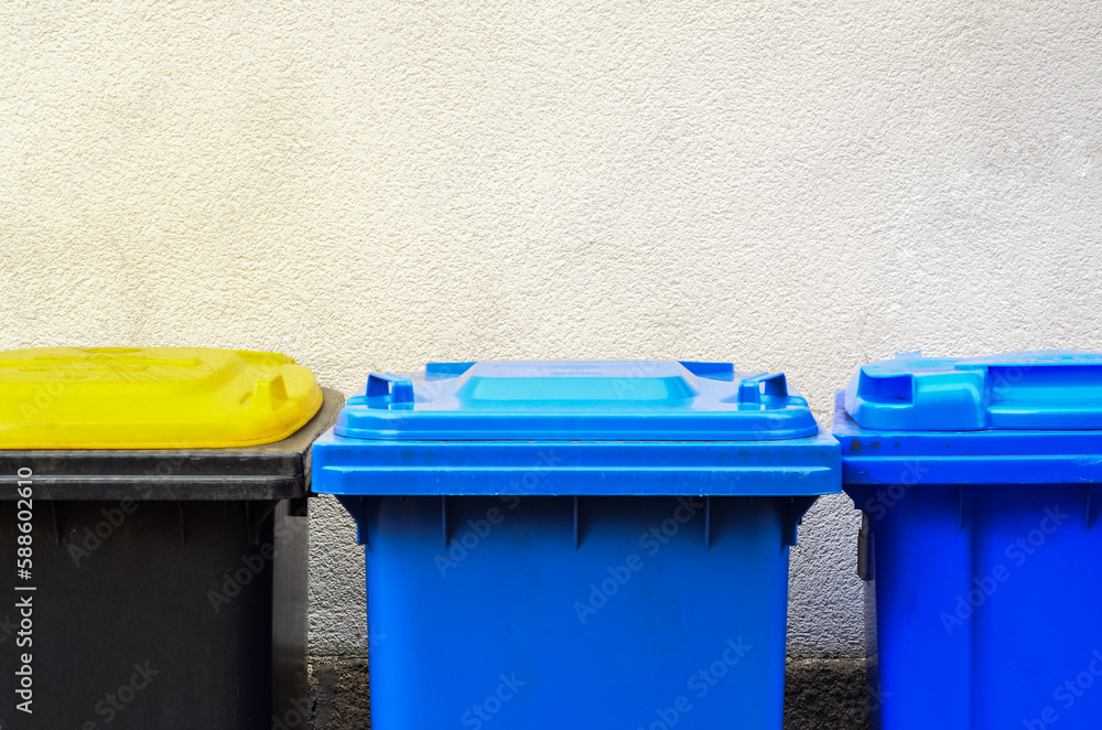 Garbage containers near building wall, closeup