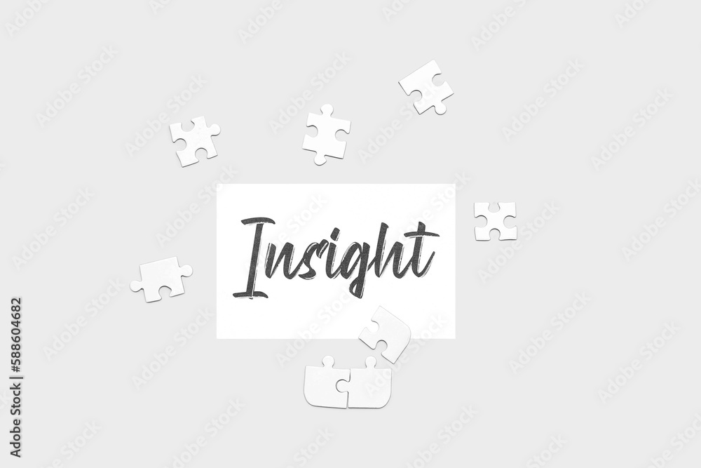 Paper with word INSIGHT and puzzle pieces on light background