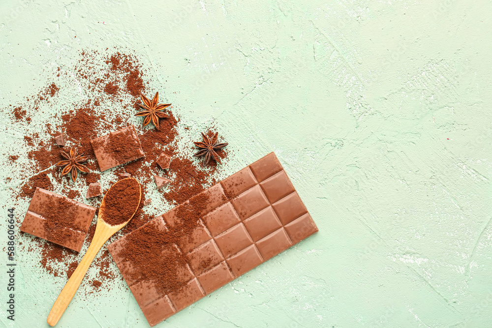 Composition with tasty chocolate, coffee powder and anise stars on green background