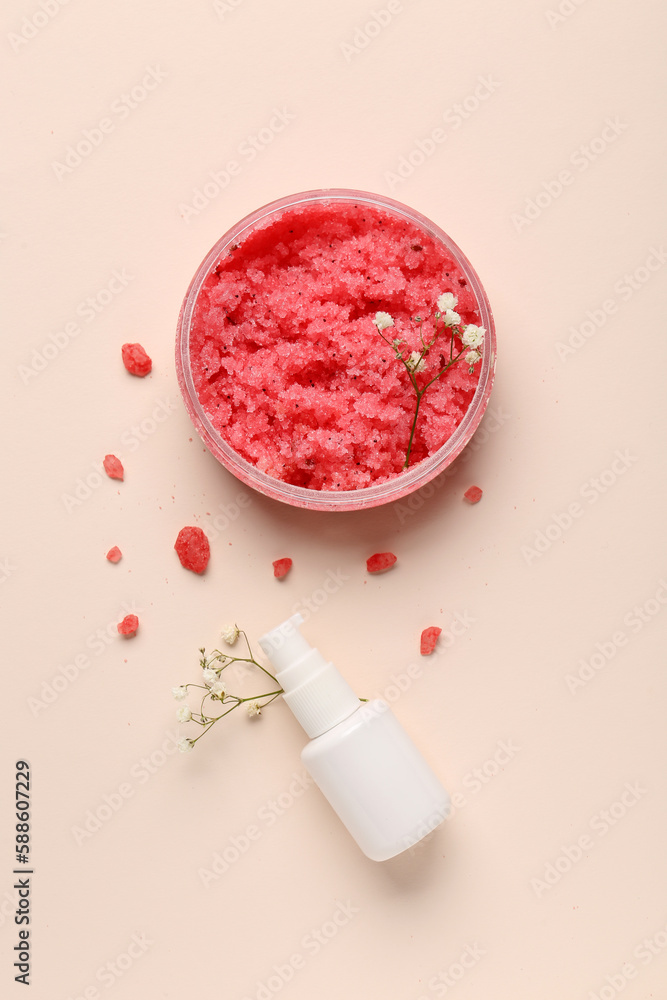 Composition with jar of body scrub, bottle of cosmetic product and gypsophila flowers on color backg