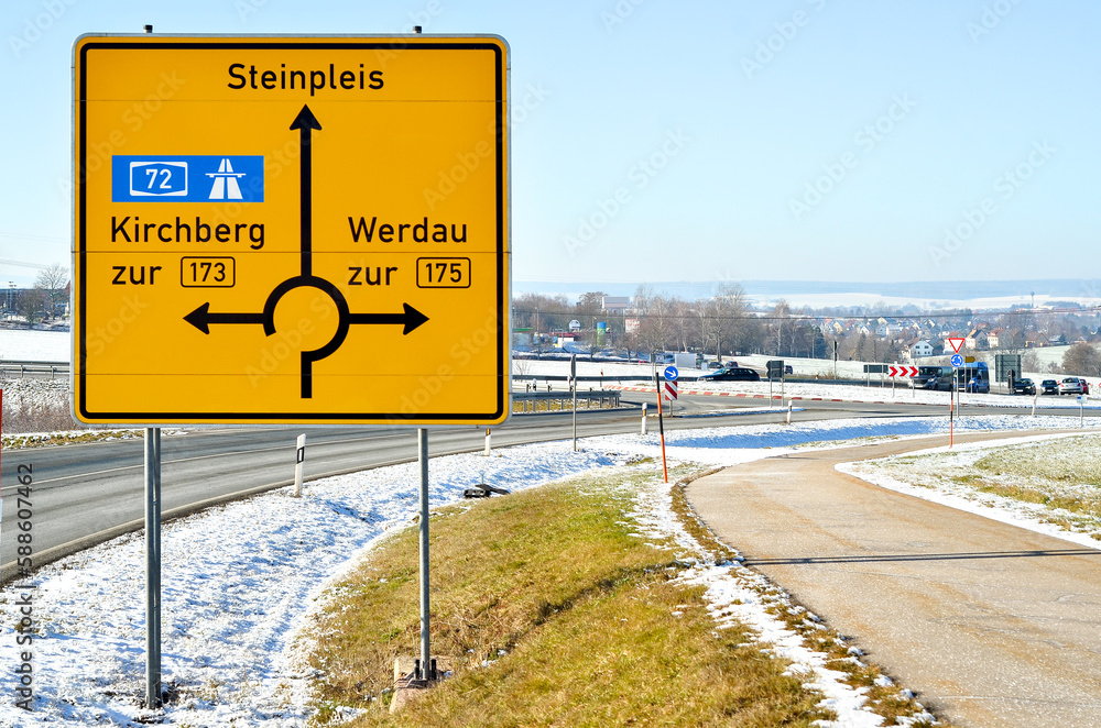 View of directional road sign on winter day