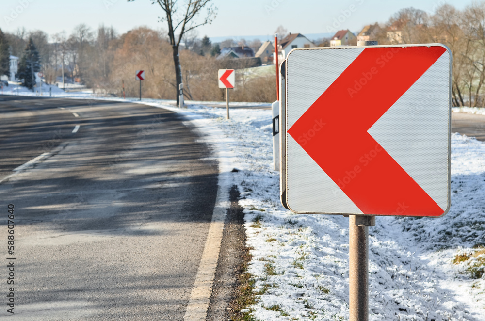 Turn left sign on winter day, closeup